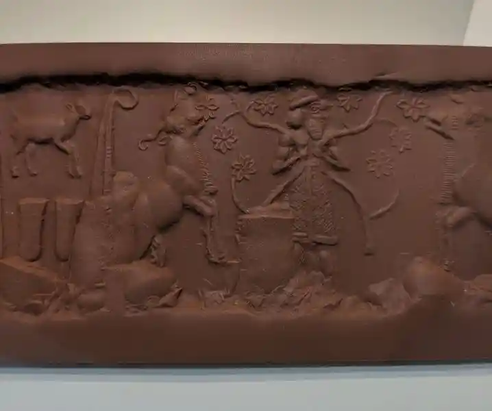 Seal, two so-called bundles of reed rings, symbols of the goddess Inana, frame the feeding of caprids by a high dignitary